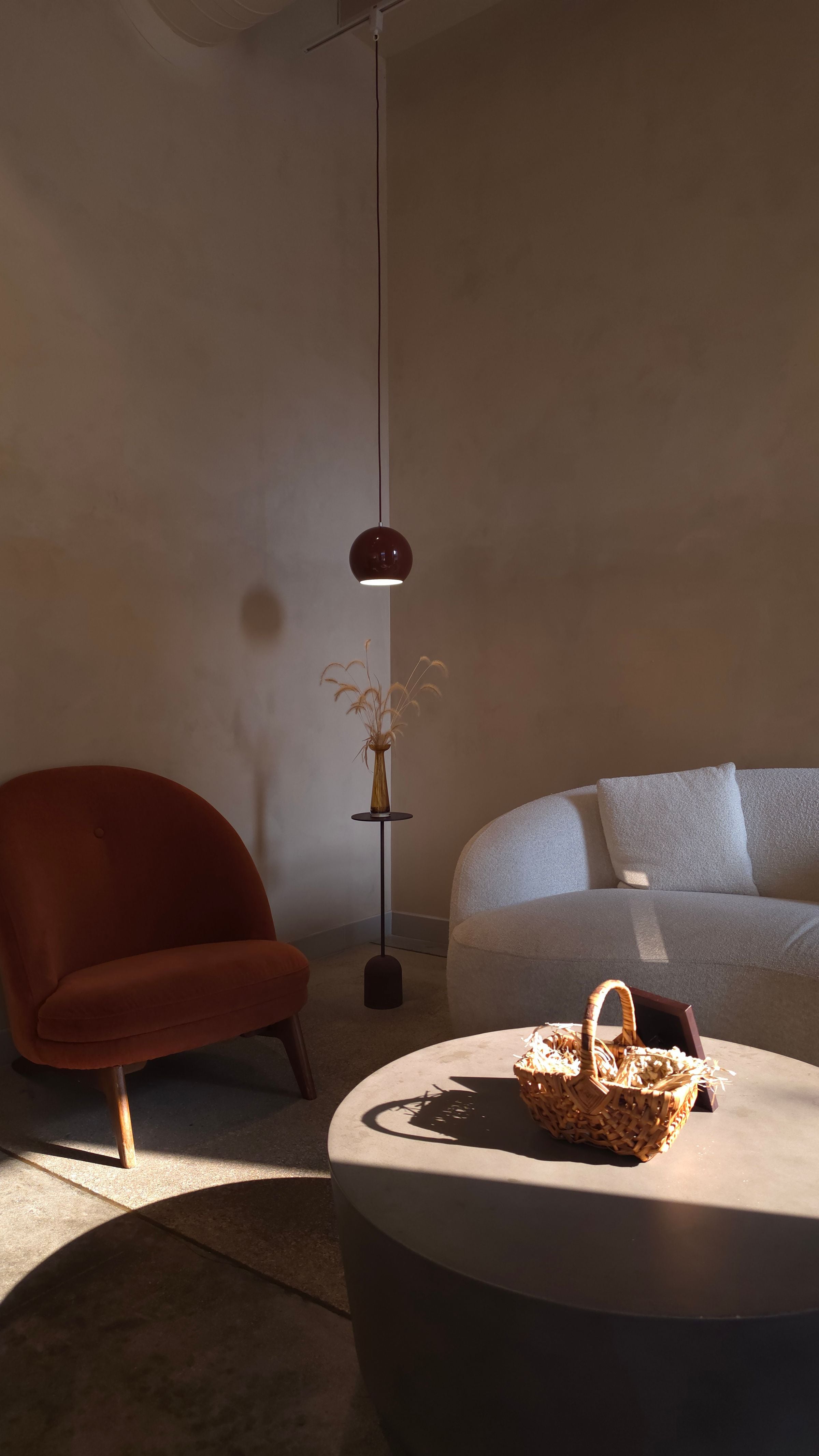 A cozy, minimalist living room with warm tones and modern furniture design.