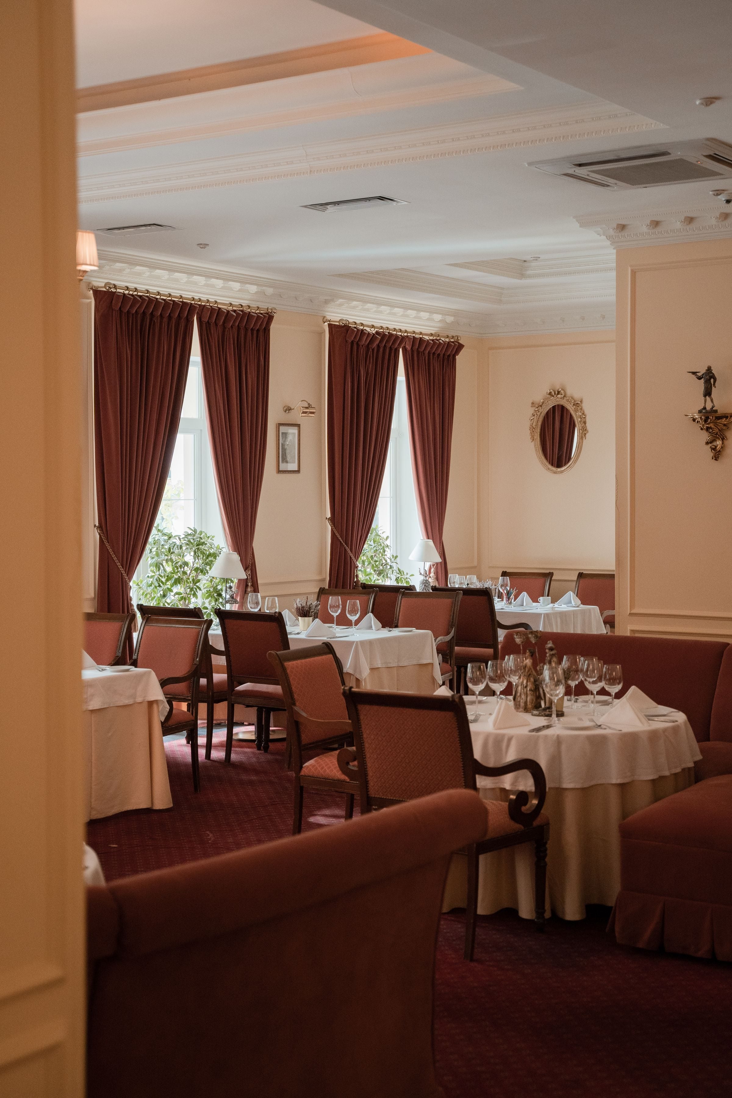 Spacious dining room interior featuring elegant decor and vintage furnishings.