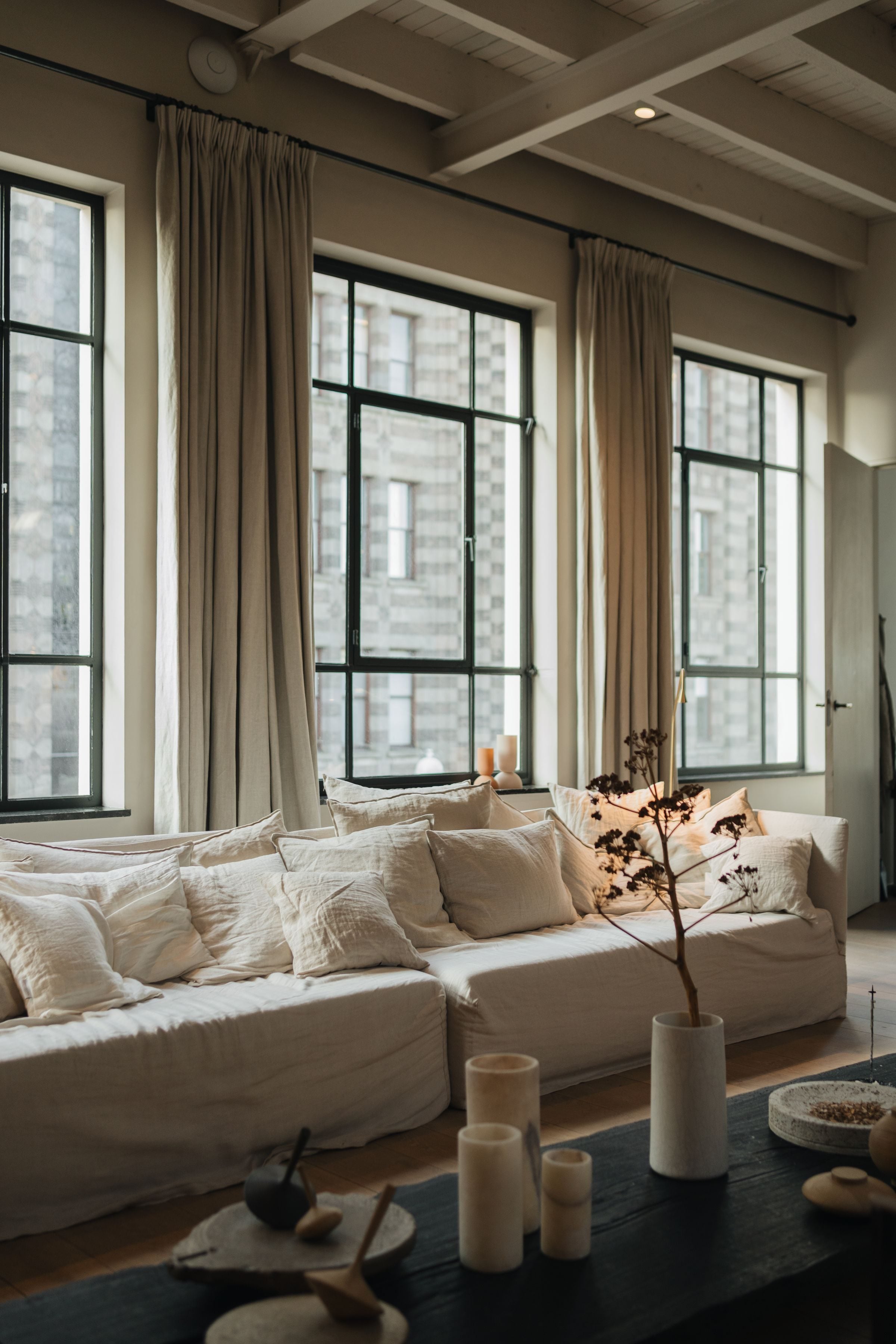 Elegant living room interior in Amsterdam with plush sofas and natural light.